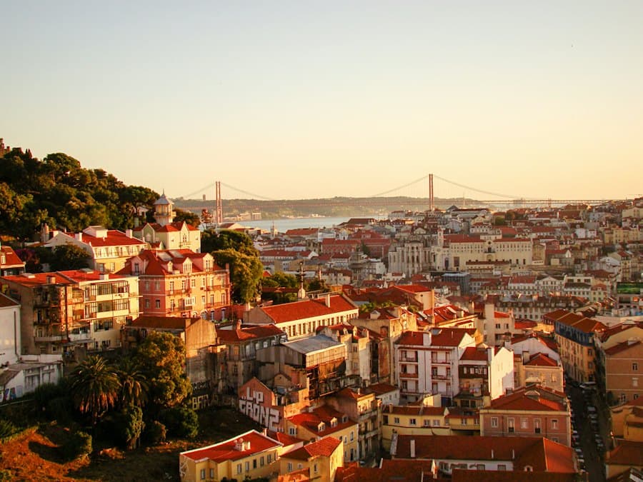 Lisbon’s rooftops at sunset with the bridge over the Tagus behind