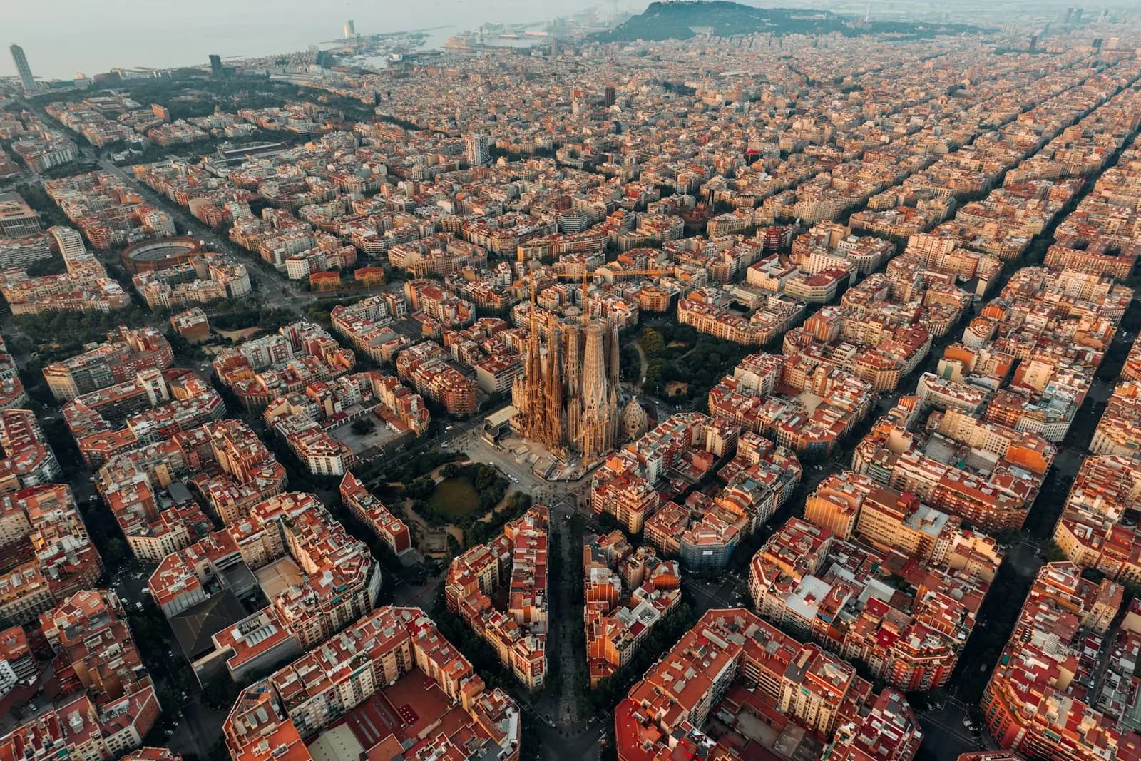 Aerial view of the Sagrada Família rising from Eixample’s grid of city blocks