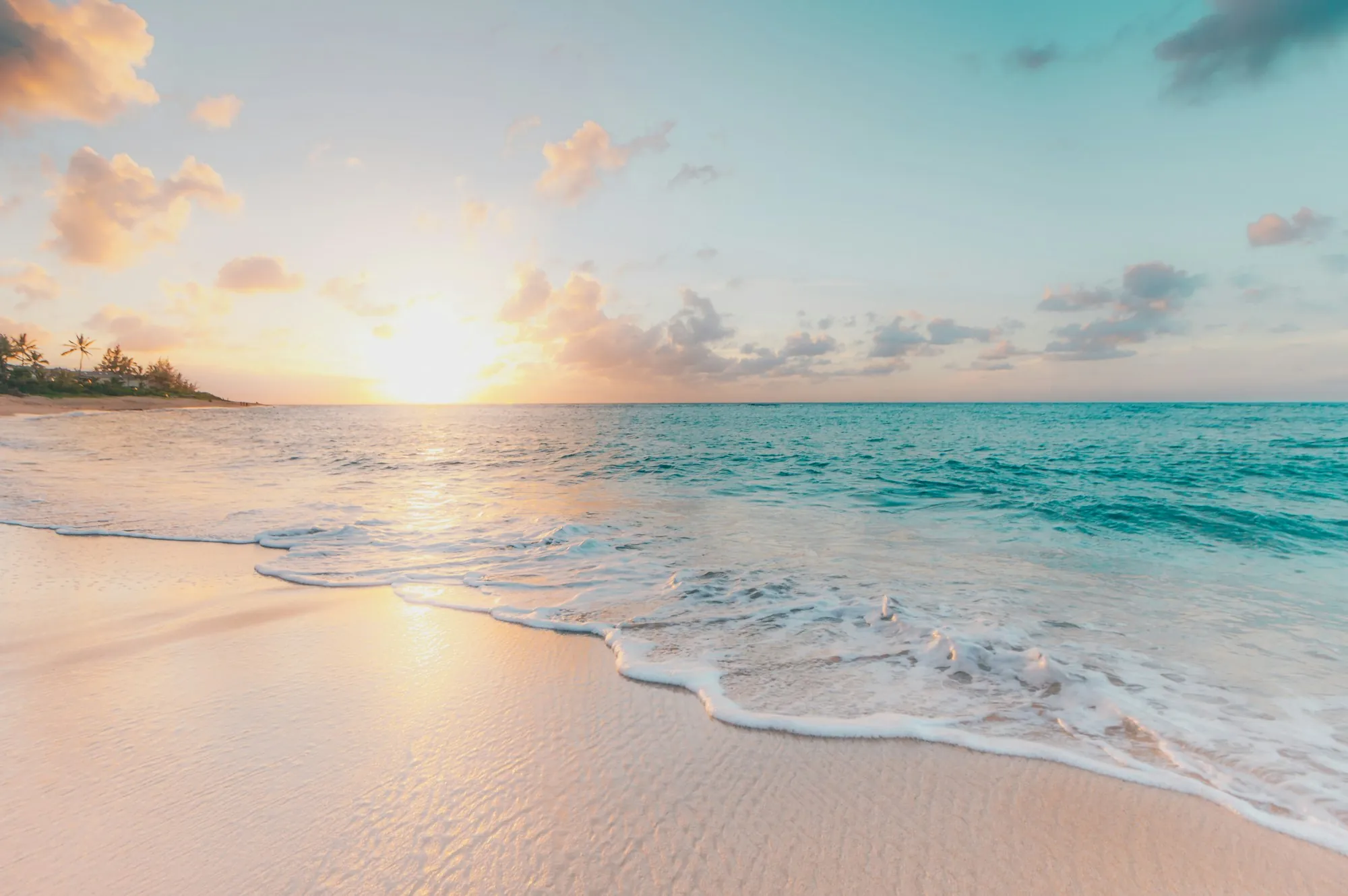 Waves on a sandy beach at sunset