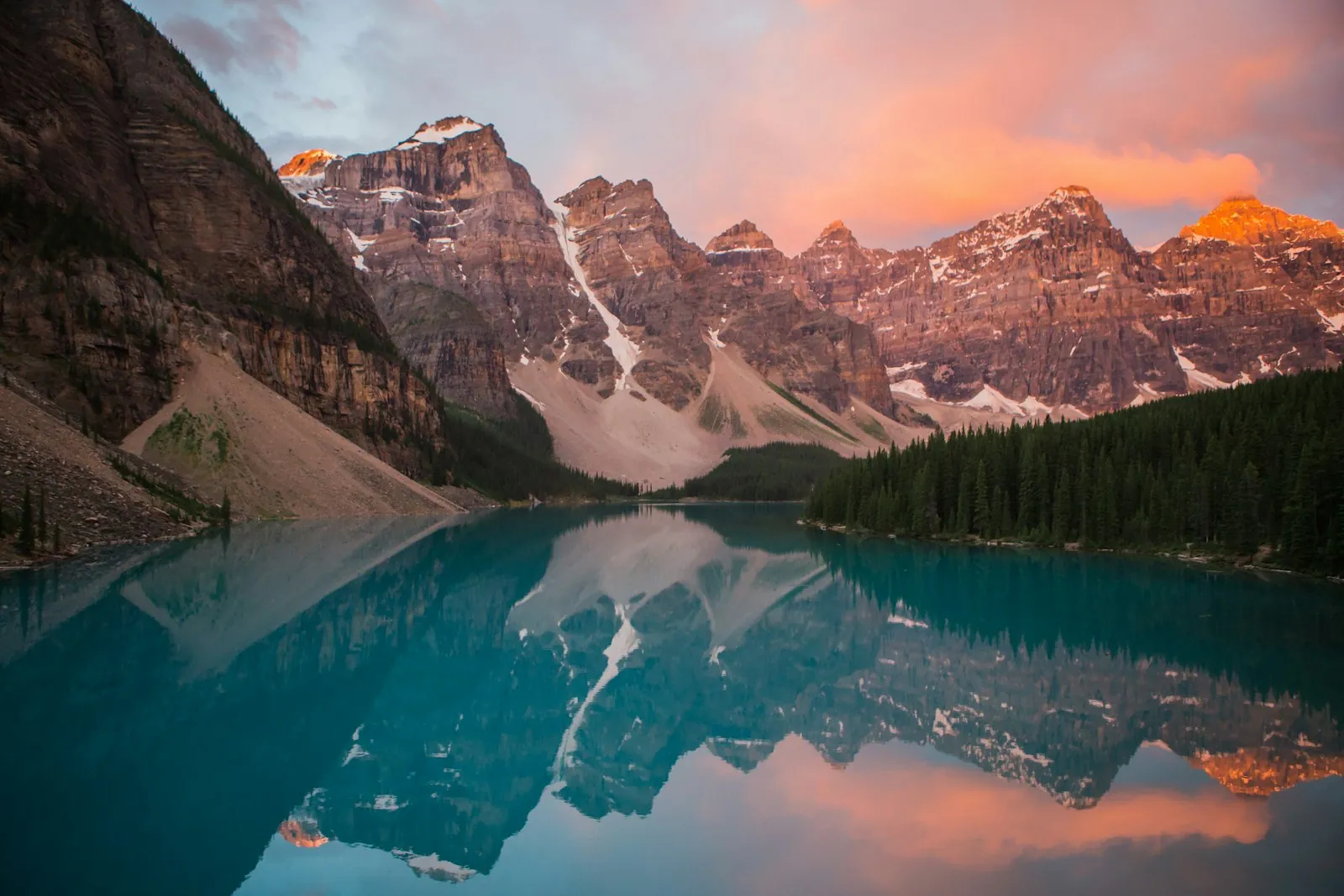 Moraine Lake beneath snowy peaks at sunrise